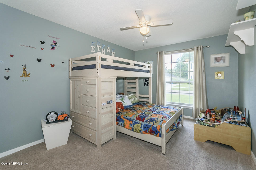 12171 Captiva Bluff Road Jacksonville, FL 32226 - Photo 23 of 36 a bedroom with bed and a window