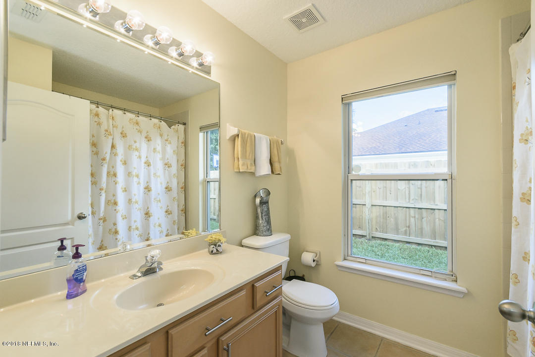 12171 Captiva Bluff Road Jacksonville, FL 32226 - Photo 24 of 36 a bathroom with a sink a toilet and shower