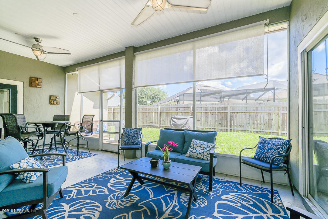 12171 Captiva Bluff Road Jacksonville, FL 32226 - Photo 27 of 36 a living room with furniture and a large window