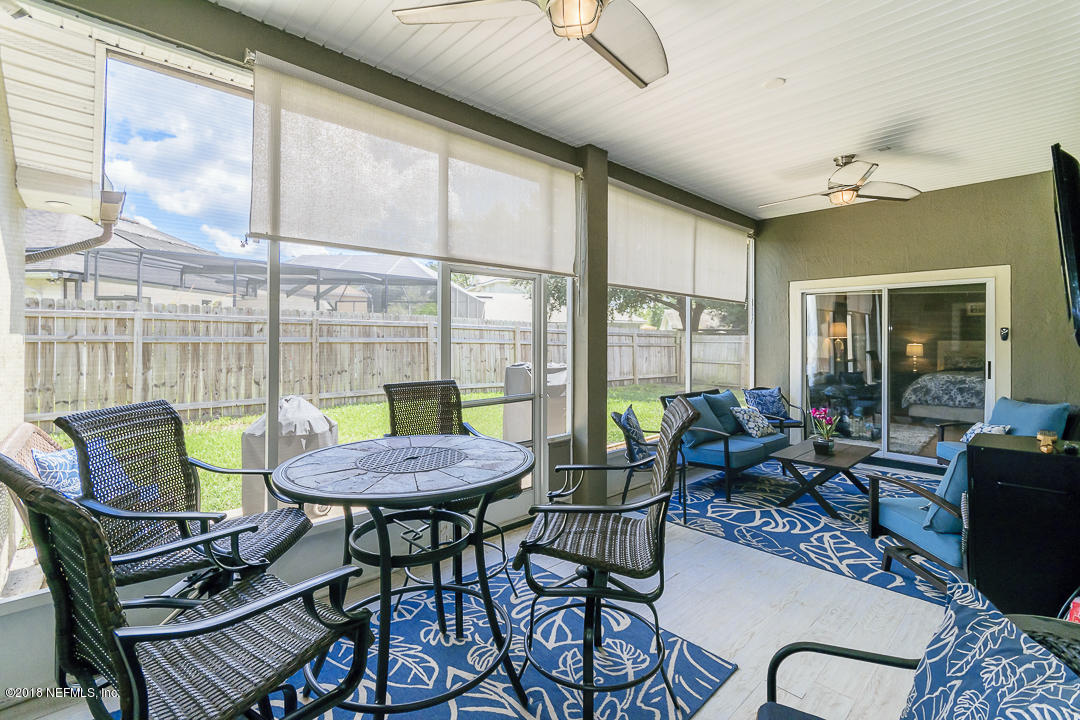 12171 Captiva Bluff Road Jacksonville, FL 32226 - Photo 28 of 36 a living room with furniture and a table