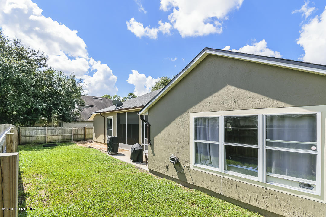 12171 Captiva Bluff Road Jacksonville, FL 32226 - Photo 29 of 36 a view of a house with a yard