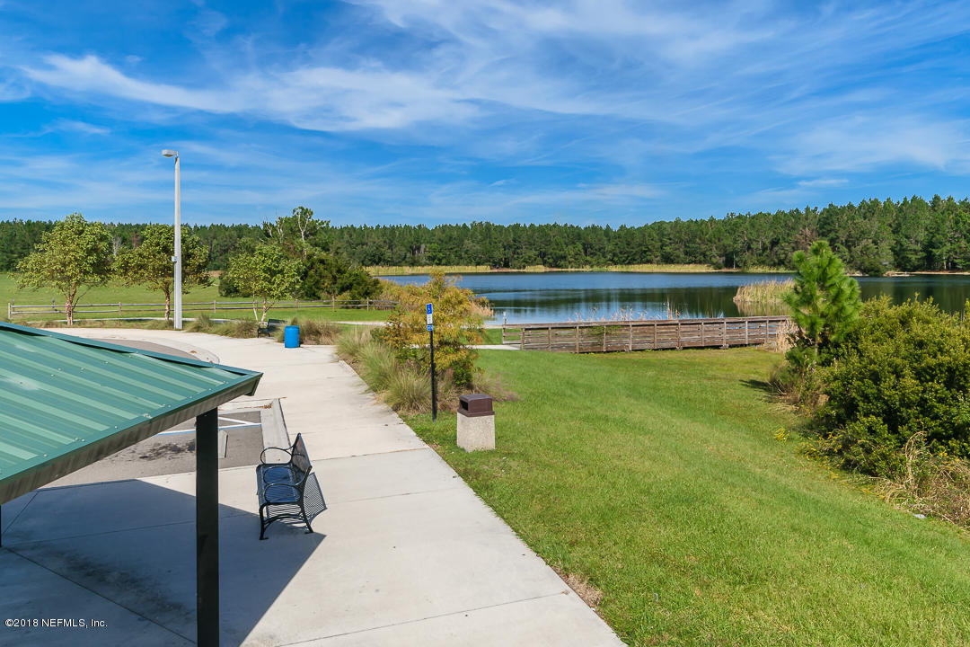 12171 Captiva Bluff Road Jacksonville, FL 32226 - Photo 34 of 36 a view of a lake with a floor to ceiling window next to a yard