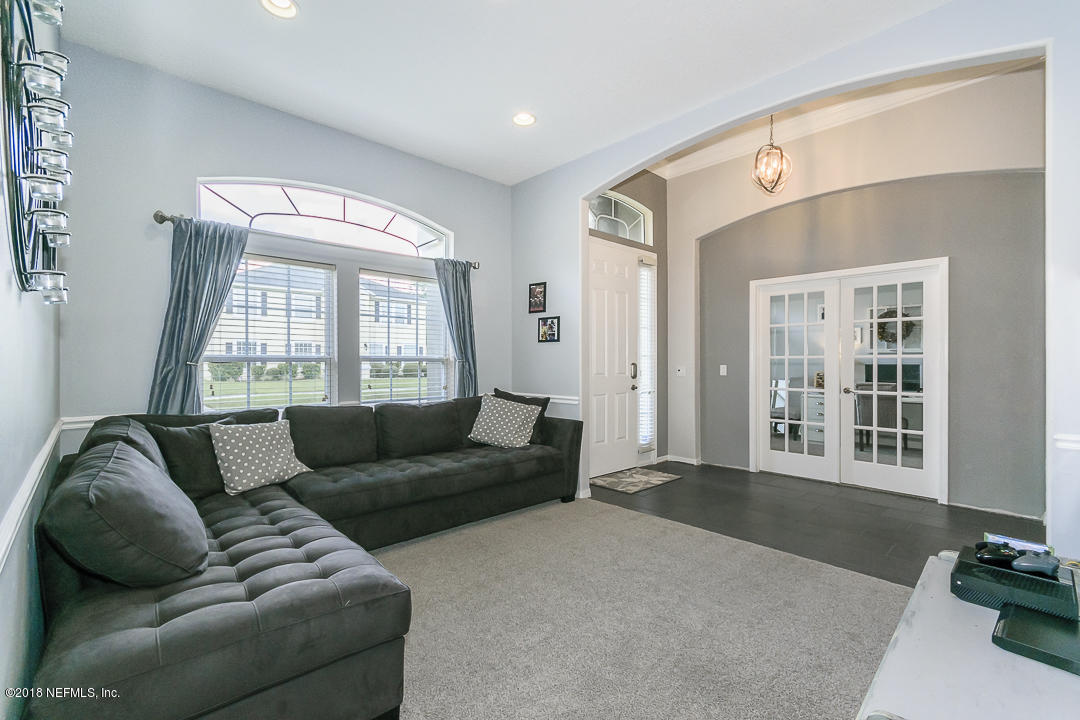 12171 Captiva Bluff Road Jacksonville, FL 32226 - Photo 5 of 36 a living room with furniture and windows