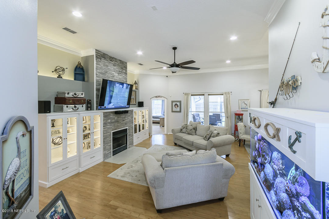 12171 Captiva Bluff Road Jacksonville, FL 32226 - Photo 7 of 36 a living room with furniture and a fireplace