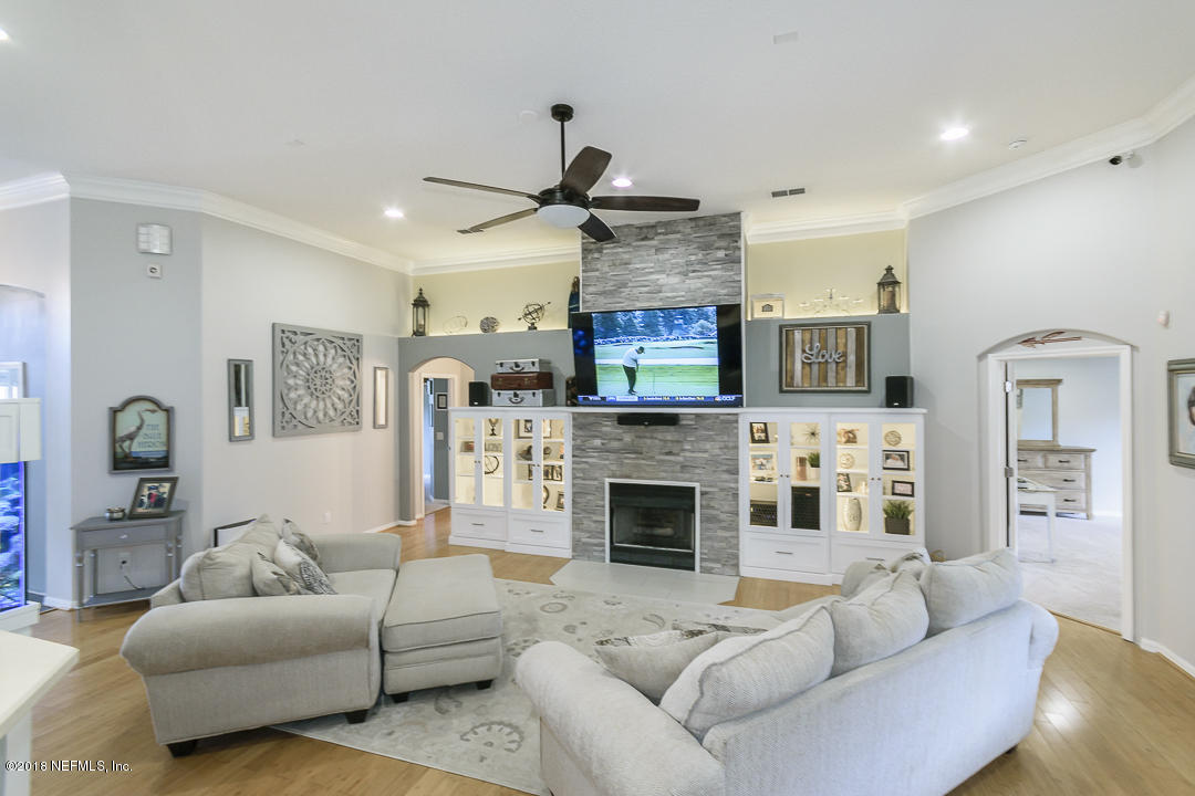 12171 Captiva Bluff Road Jacksonville, FL 32226 - Photo 9 of 36 a living room with fireplace furniture and a fireplace
