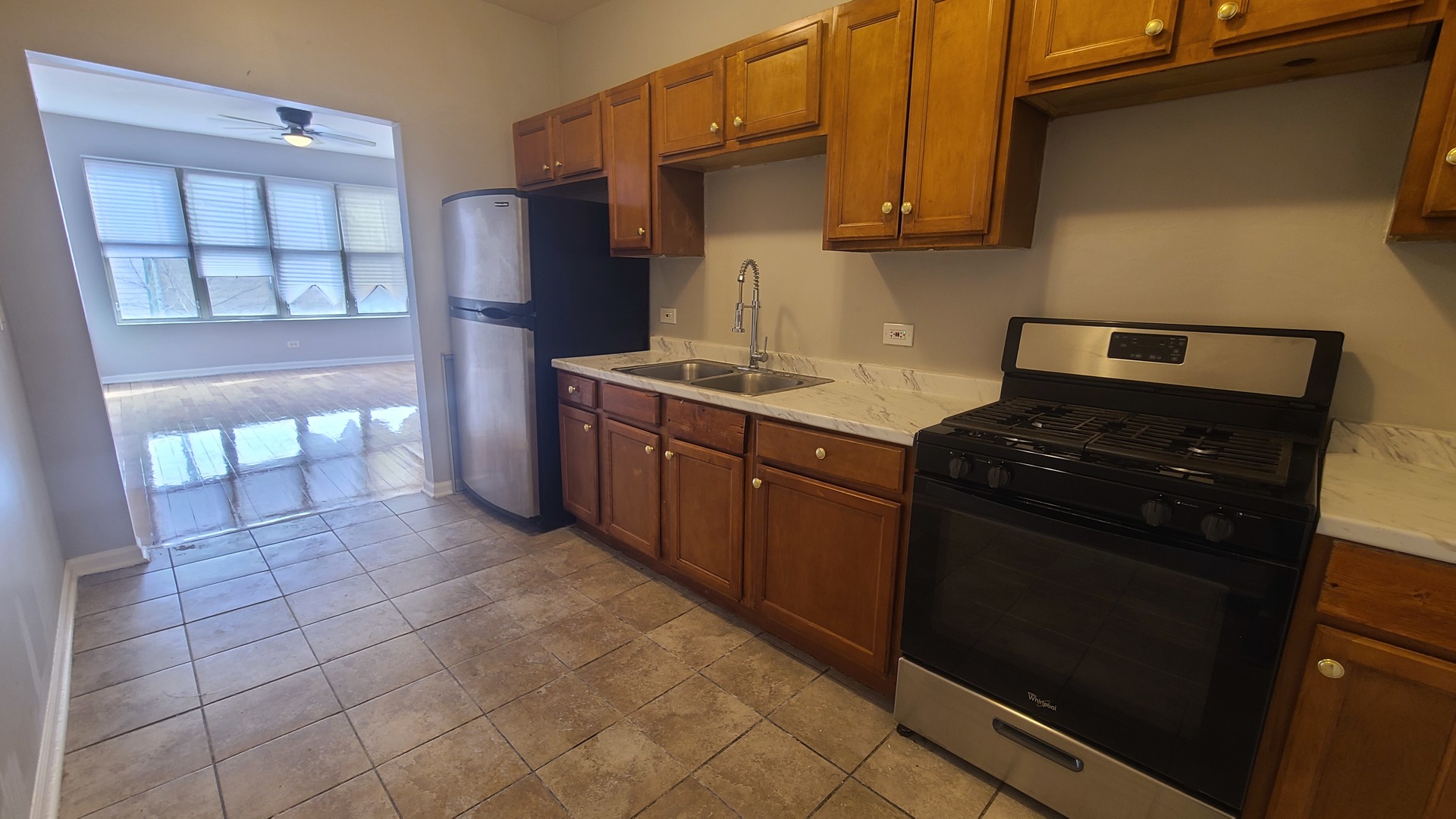 612 East Marquette Road, Unit 2 Chicago, IL 60637 - Photo 3 of 6 a kitchen with stainless steel appliances granite countertop a stove and a refrigerator