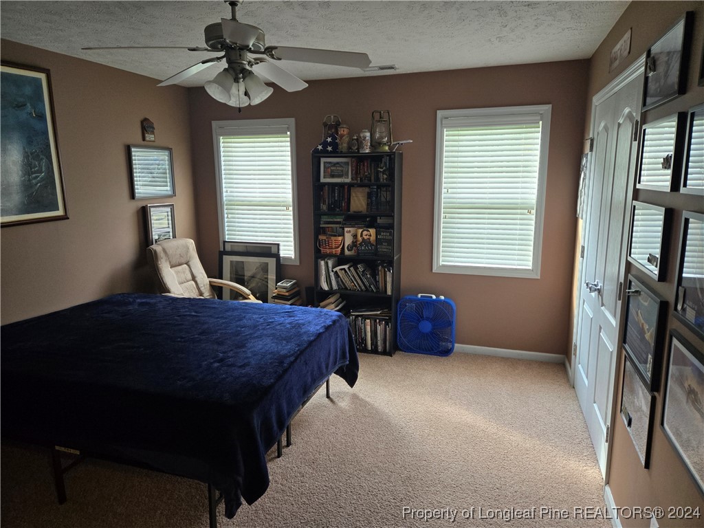 6723 Camden Road Fayetteville, NC 28306 - Photo 11 of 18 a bedroom with a bed dresser and a window