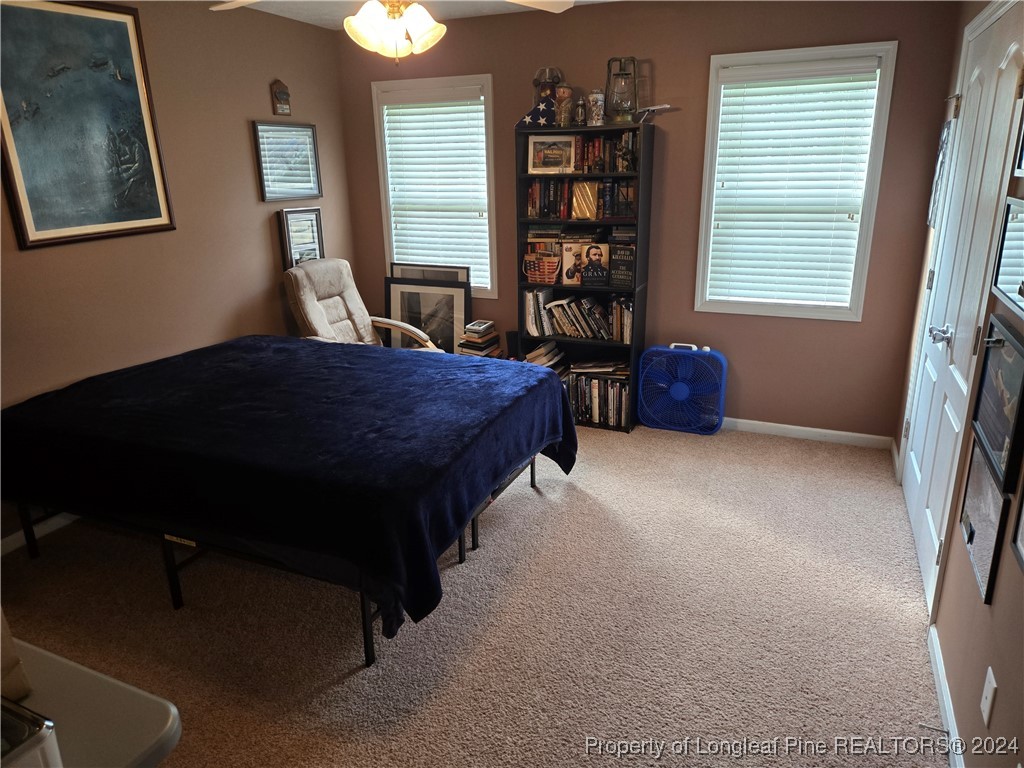 6723 Camden Road Fayetteville, NC 28306 - Photo 12 of 18 a bedroom with a bed and a window