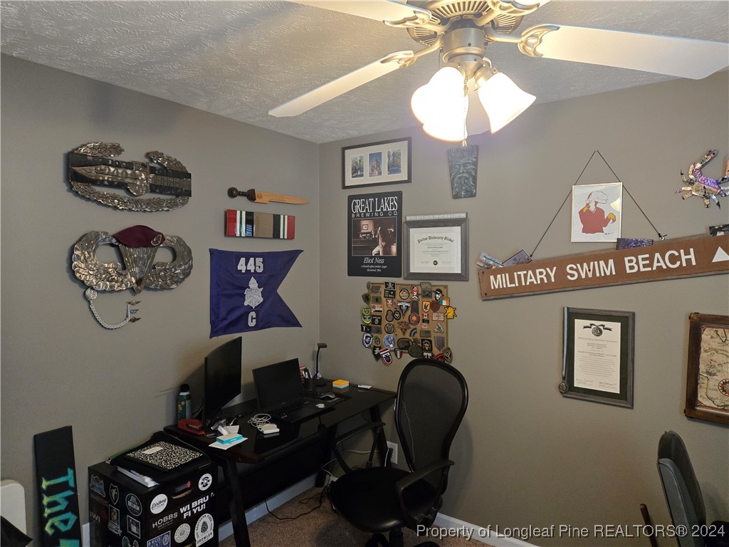 6723 Camden Road Fayetteville, NC 28306 - Photo 15 of 18 a room with furniture and paintings on the wall