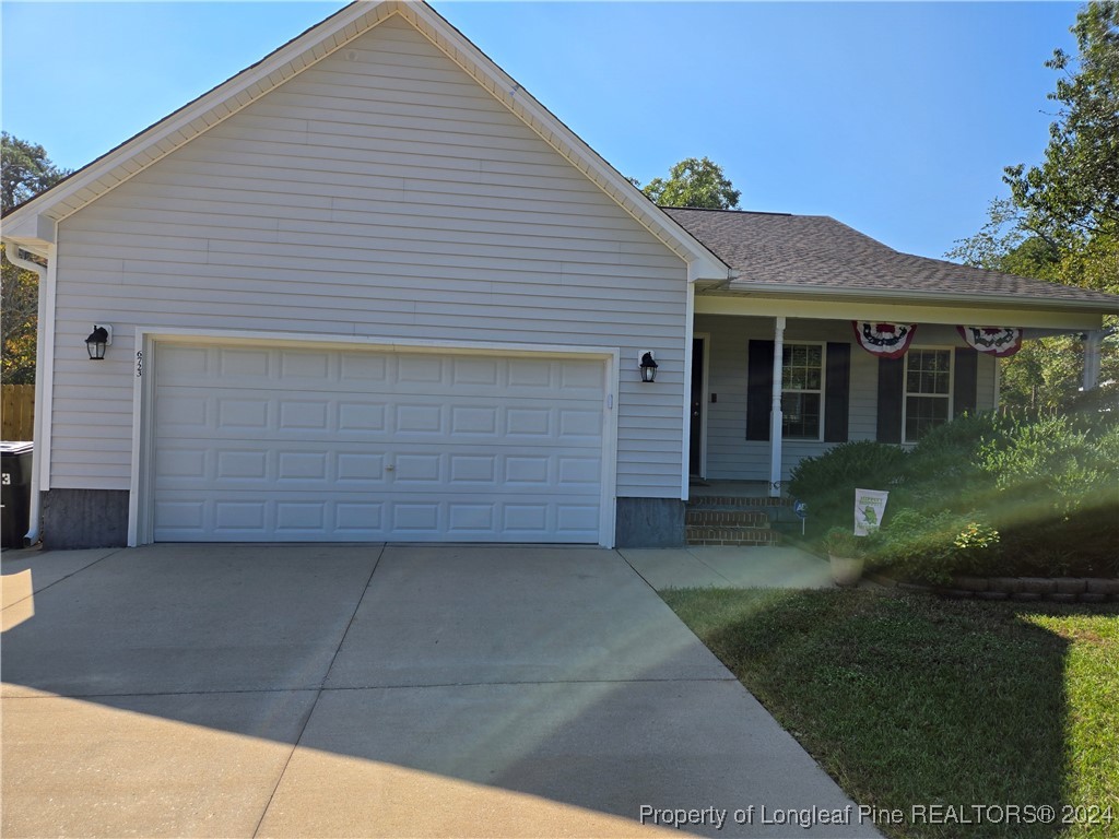 6723 Camden Road Fayetteville, NC 28306 - Photo 2 of 18 a front view of a house with a garden