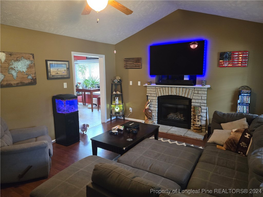 6723 Camden Road Fayetteville, NC 28306 - Photo 5 of 18 a living room with furniture fireplace and flat screen tv