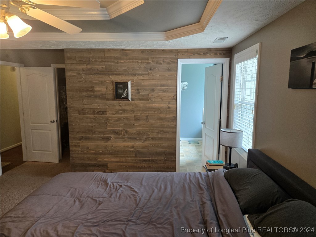 6723 Camden Road Fayetteville, NC 28306 - Photo 8 of 18 a bedroom with a bed and a flat screen tv