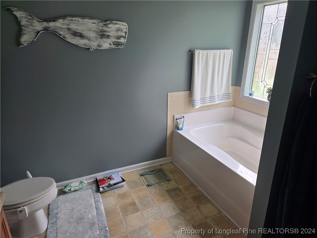 6723 Camden Road Fayetteville, NC 28306 - Photo 9 of 18 a bathroom with a sink and a toilet