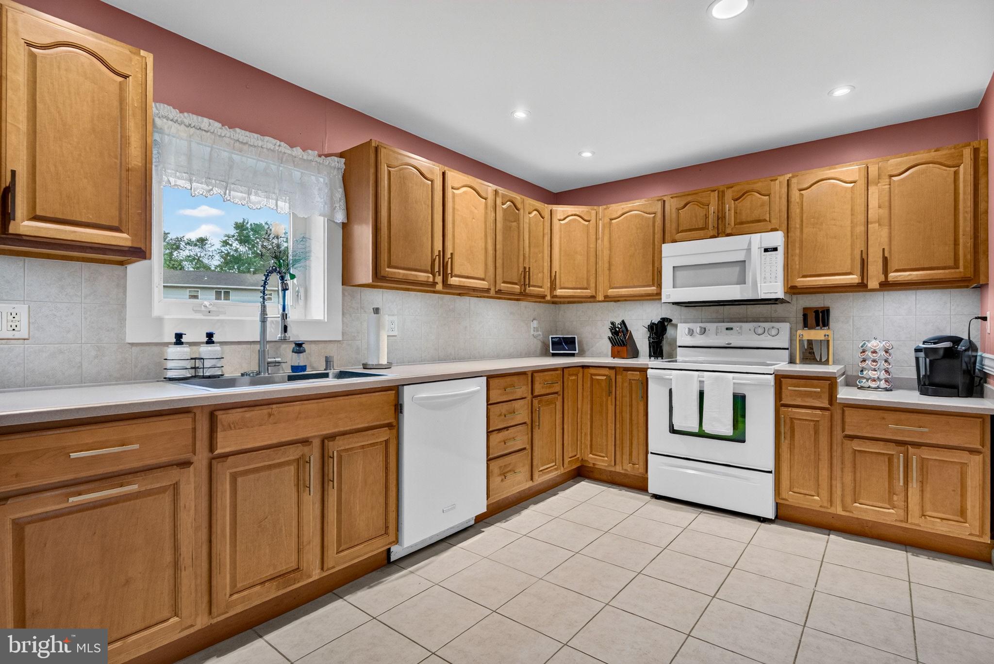 12 Woodbridge Road Gibbsboro, NJ 08026 - Photo 20 of 45 a kitchen with granite countertop cabinets stainless steel appliances a sink and a window