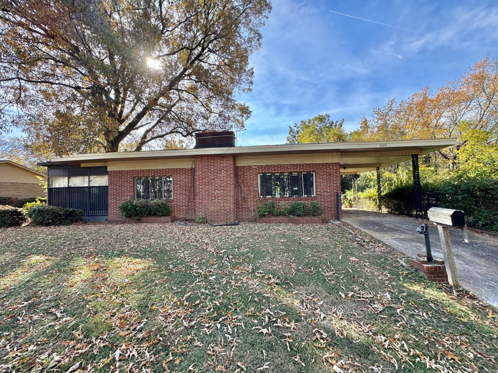 3085 Hoskins Road Memphis, TN 38111 - Photo 1 of 14 View of front facade with an attached carport, brick siding, a chimney, a front lawn, and concrete driveway