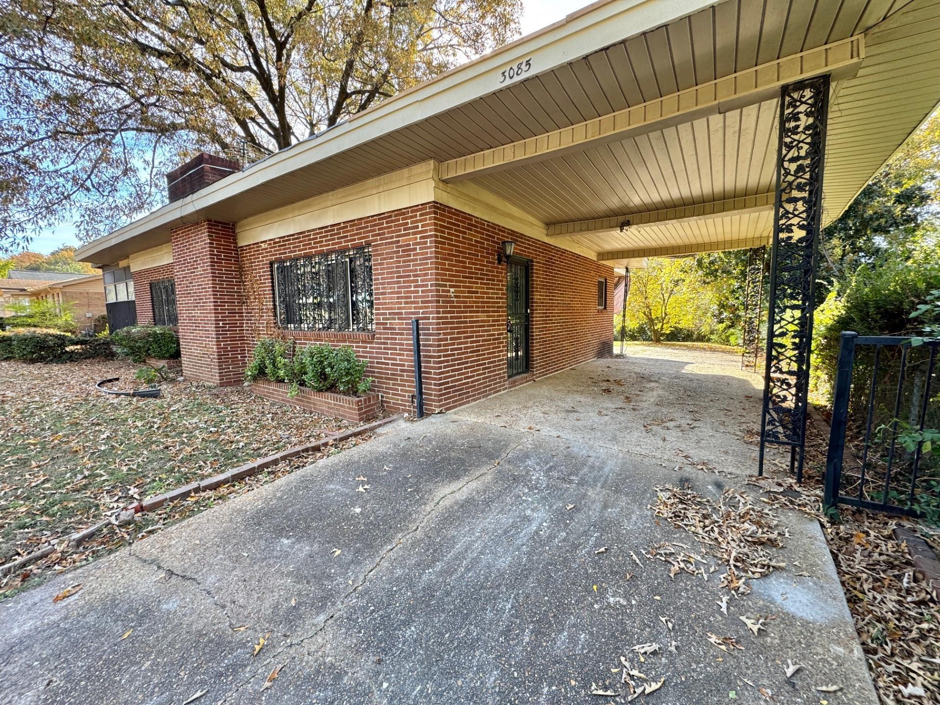 3085 Hoskins Road Memphis, TN 38111 - Photo 3 of 14 View of side of property with a chimney, brick siding, driveway, and a carport