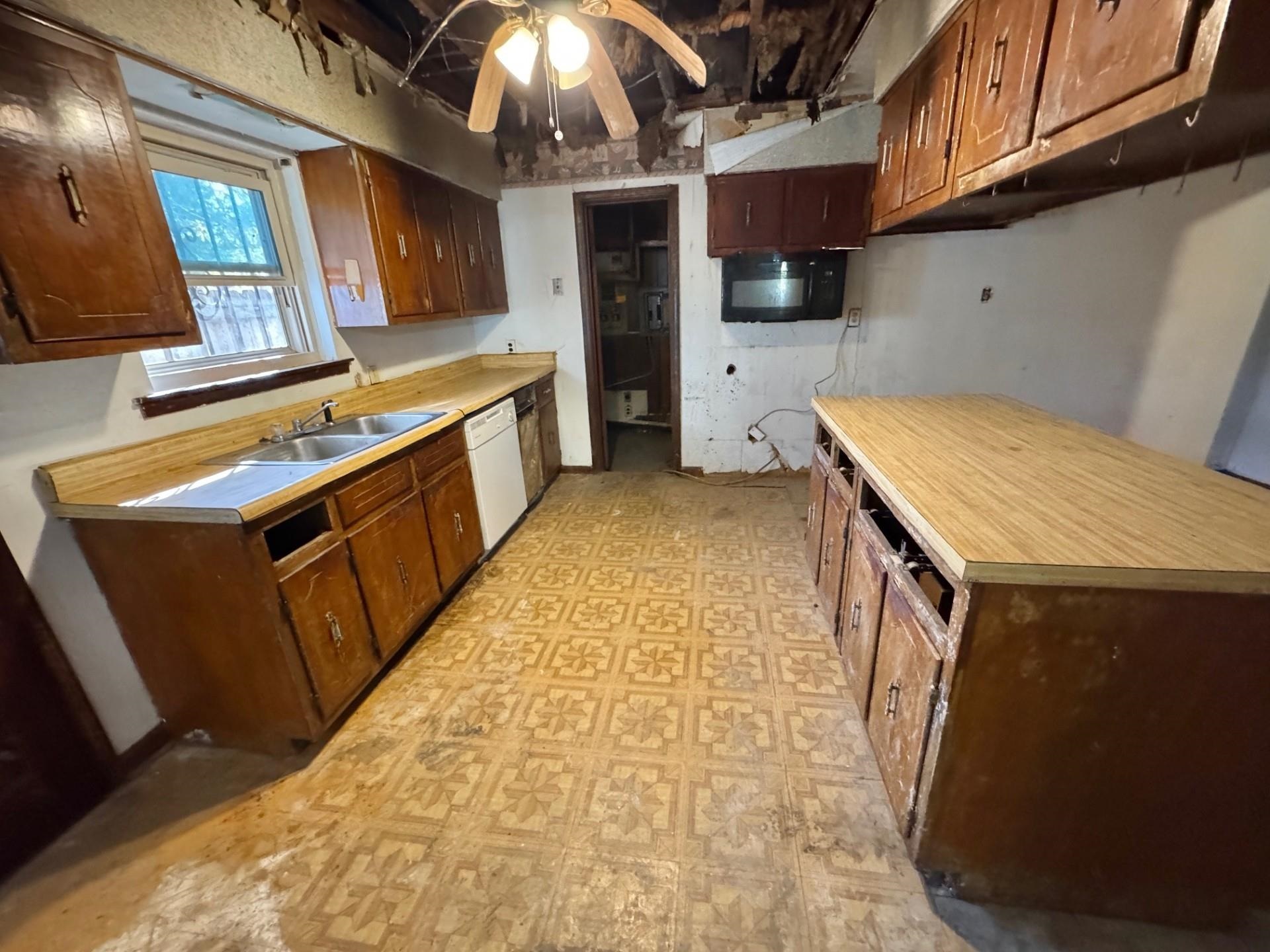 3085 Hoskins Road Memphis, TN 38111 - Photo 7 of 14 Kitchen featuring light floors, light countertops, white dishwasher, and a ceiling fan