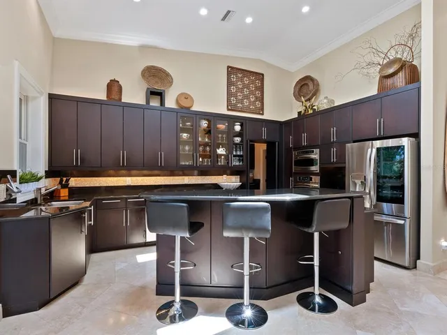 a view of empty room with kitchen and window