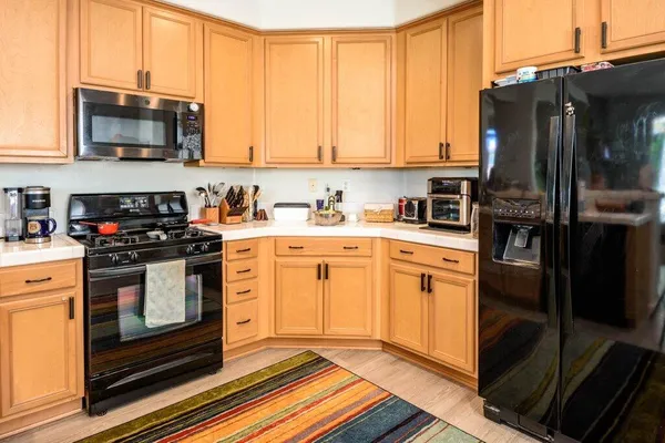 a living room with granite countertop furniture a flat screen tv and a table