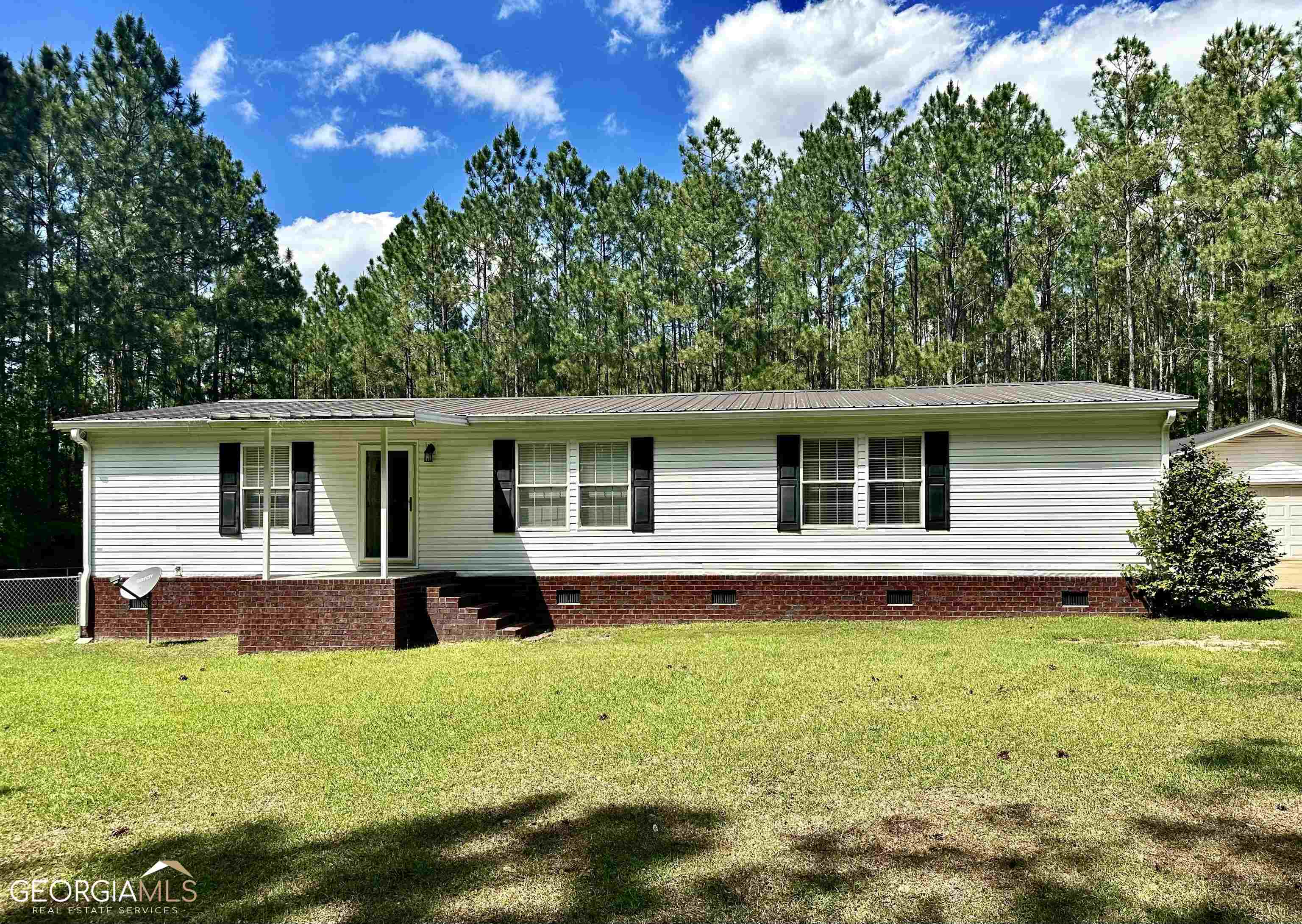 210 Frank Sikes Road Claxton, GA 30417 - Photo 1 of 1 a house view with a garden space