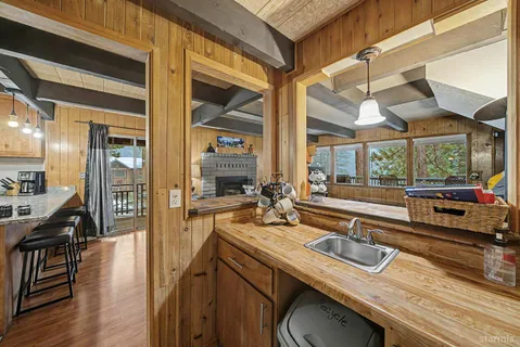 a kitchen with a sink and wooden floor