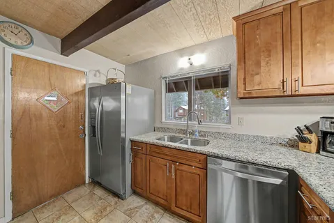 a kitchen with stainless steel appliances granite countertop a sink and cabinets