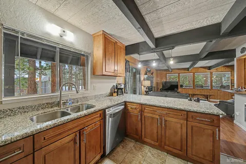 a kitchen with granite countertop a sink and cabinets