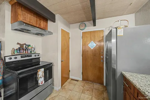 a kitchen with stainless steel appliances granite countertop a stove and a refrigerator