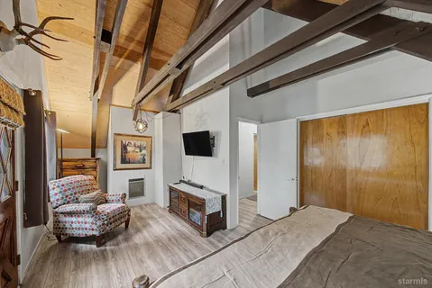a bedroom with furniture and a flat screen tv