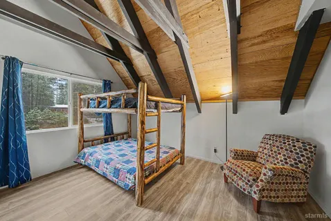a bedroom with furniture and a window