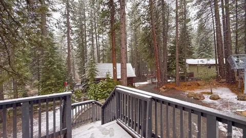 a view of a wooden fence and trees