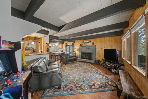 a living room with furniture a flat screen tv and a fireplace