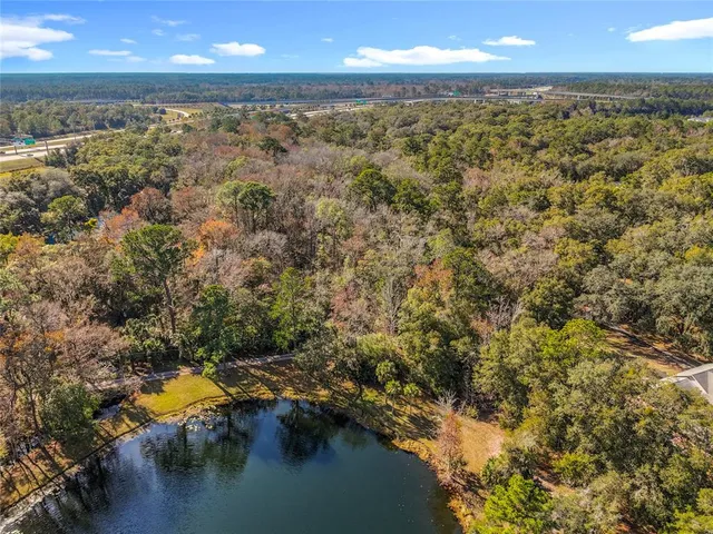 a view of a yard with a wooden fence