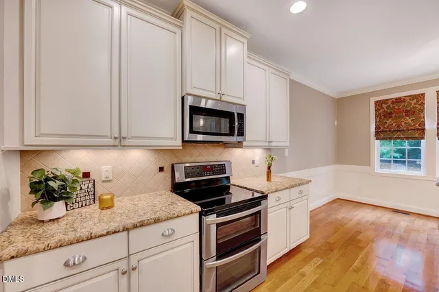 a kitchen with stainless steel appliances granite countertop a sink and microwave