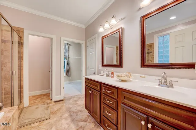 an empty room with chandelier fan and windows