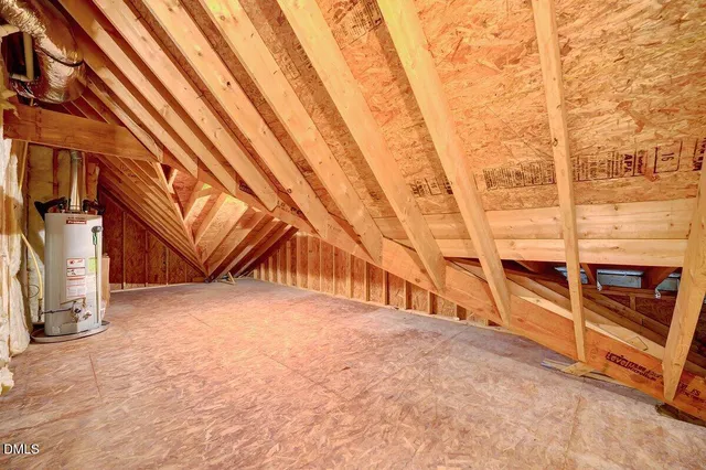 an empty room with chandelier fan and windows