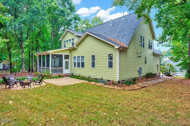 a view of a house with backyard sitting area and garden