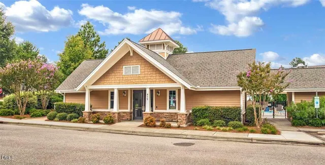 a view of a swimming pool with a patio and a garden