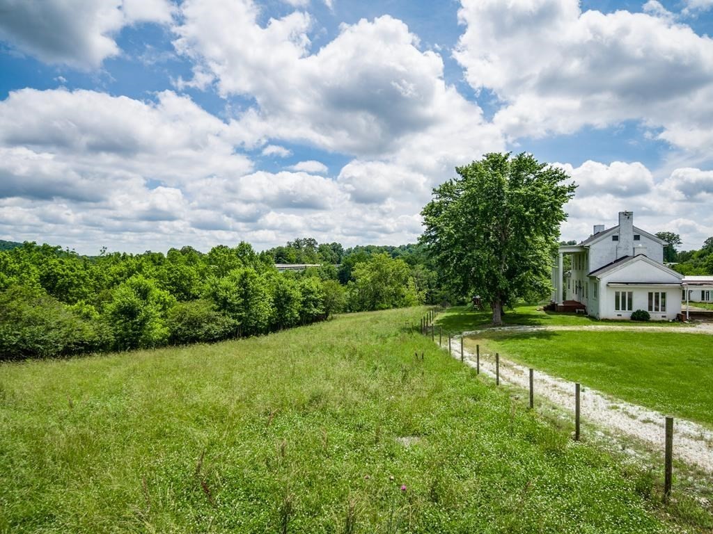 899 Messenger Road Sparta, TN 38583 - Photo 12 of 68 a view of a house with a big yard and a large tree