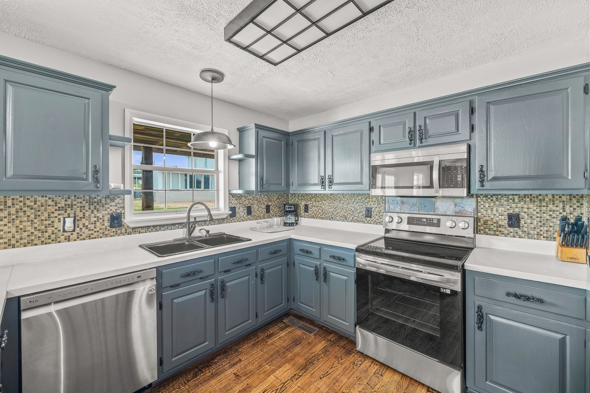 899 Messenger Road Sparta, TN 38583 - Photo 64 of 68 a kitchen with a sink stove and cabinets
