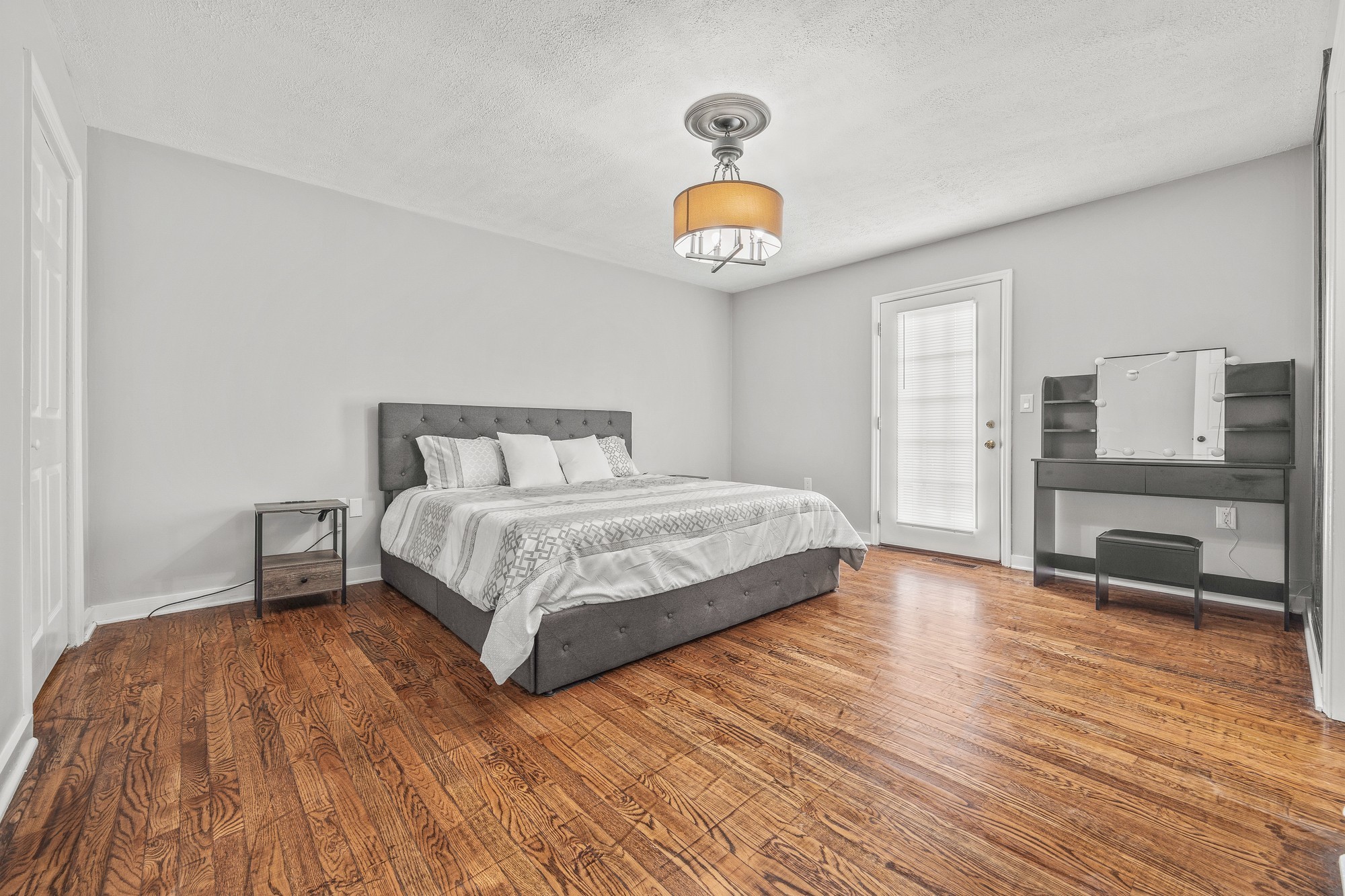 899 Messenger Road Sparta, TN 38583 - Photo 65 of 68 a bedroom with a bed and a table with wooden floor