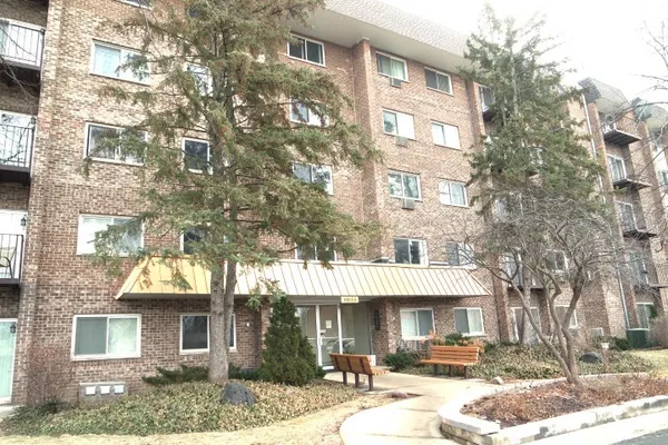 a front view of a residential apartment building with a yard