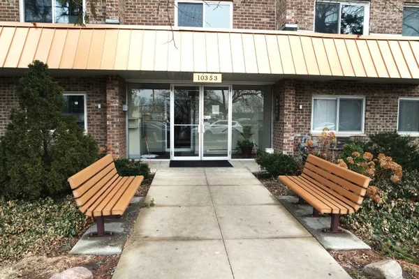 a front view of a house with garden and patio