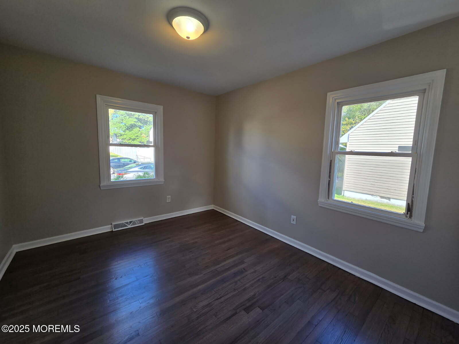 6 Trumen Place, Unit 1 Keansburg, NJ 07734 - Photo 11 of 19 an empty room with wooden floor and windows