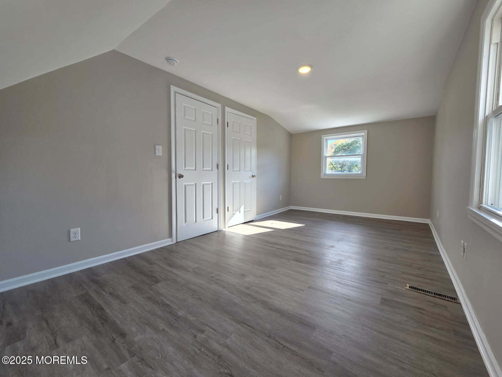 6 Trumen Place, Unit 1 Keansburg, NJ 07734 - Photo 12 of 19 an empty room with wooden floor and windows