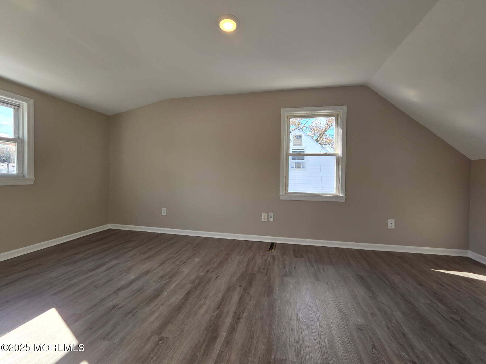 6 Trumen Place, Unit 1 Keansburg, NJ 07734 - Photo 13 of 19 an empty room with wooden floor and windows
