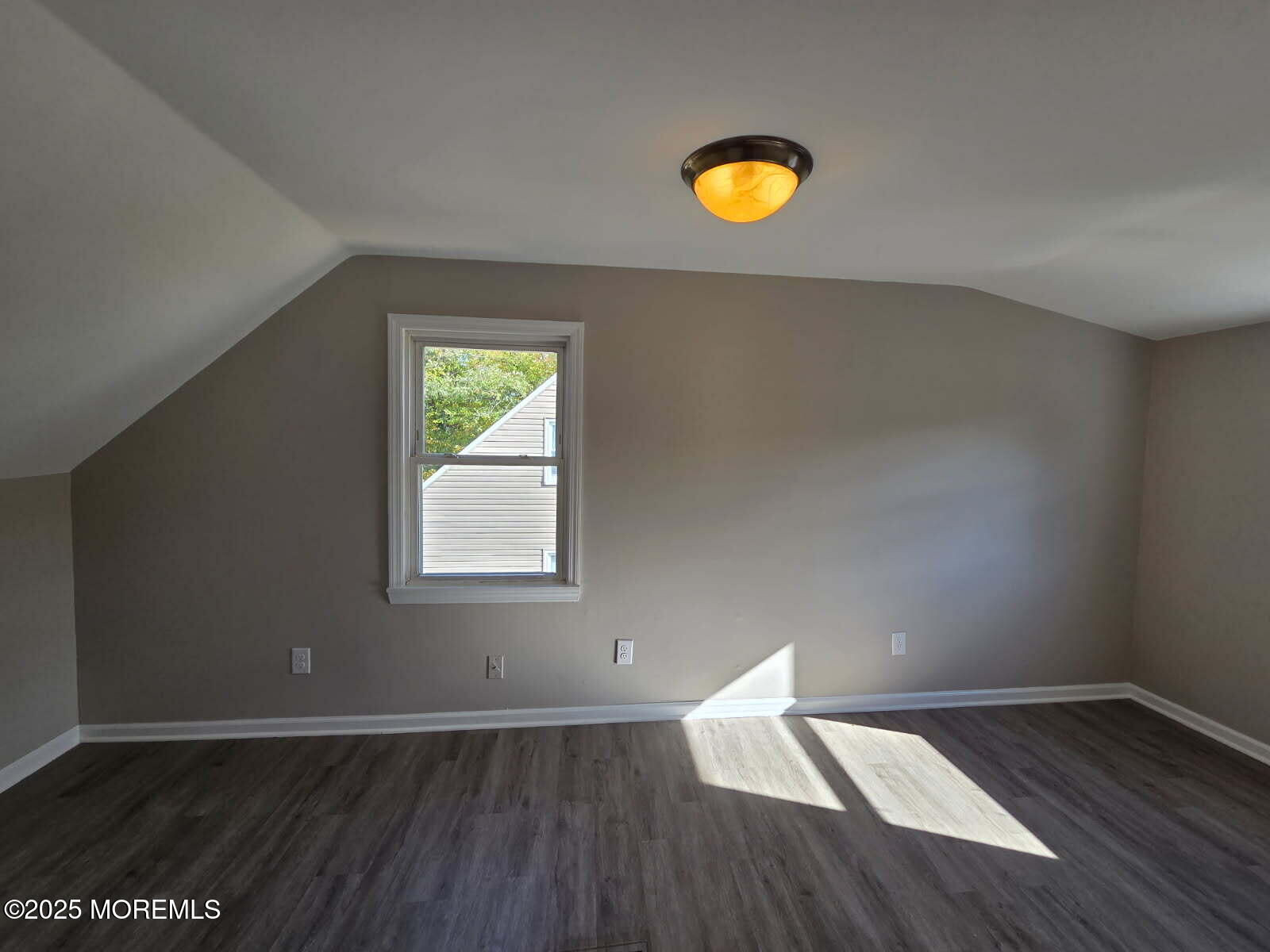 6 Trumen Place, Unit 1 Keansburg, NJ 07734 - Photo 15 of 19 an empty room with wooden floor and windows