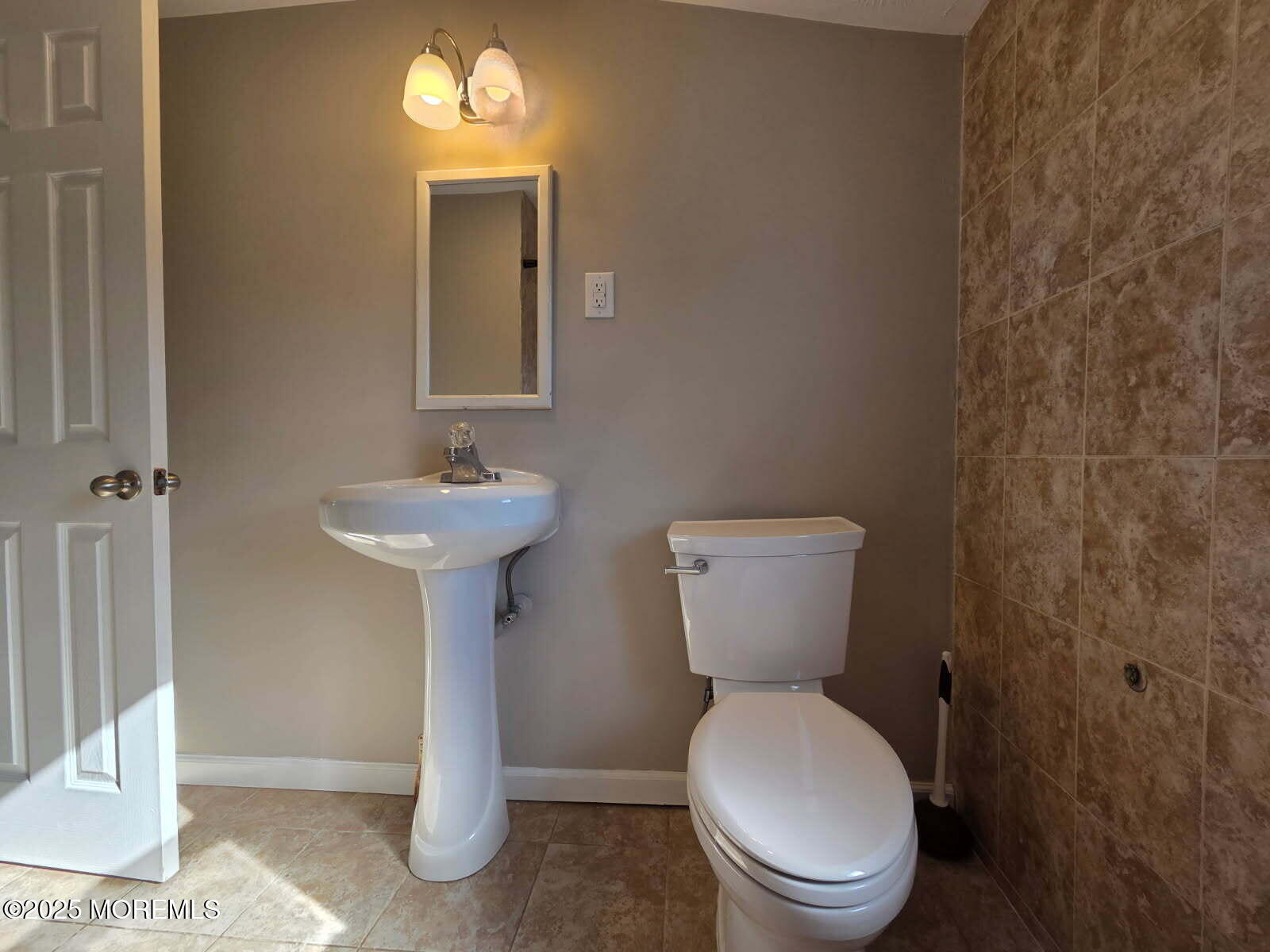 6 Trumen Place, Unit 1 Keansburg, NJ 07734 - Photo 17 of 19 a bathroom with a toilet sink and mirror
