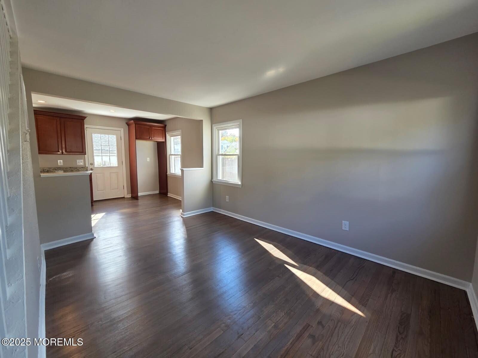 6 Trumen Place, Unit 1 Keansburg, NJ 07734 - Photo 6 of 19 an empty room with wooden floor and windows