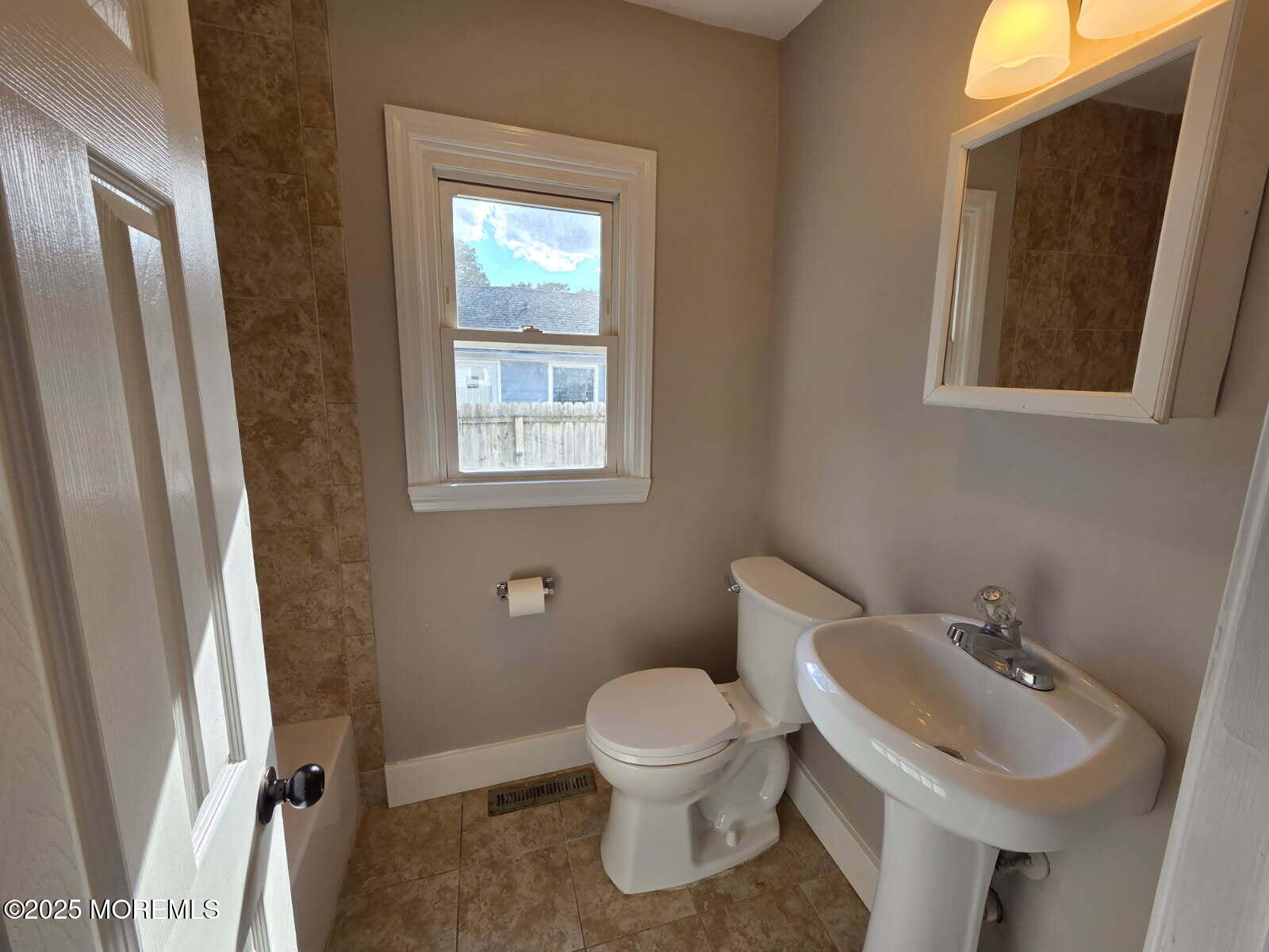 6 Trumen Place, Unit 1 Keansburg, NJ 07734 - Photo 8 of 19 a bathroom with a toilet sink and mirror